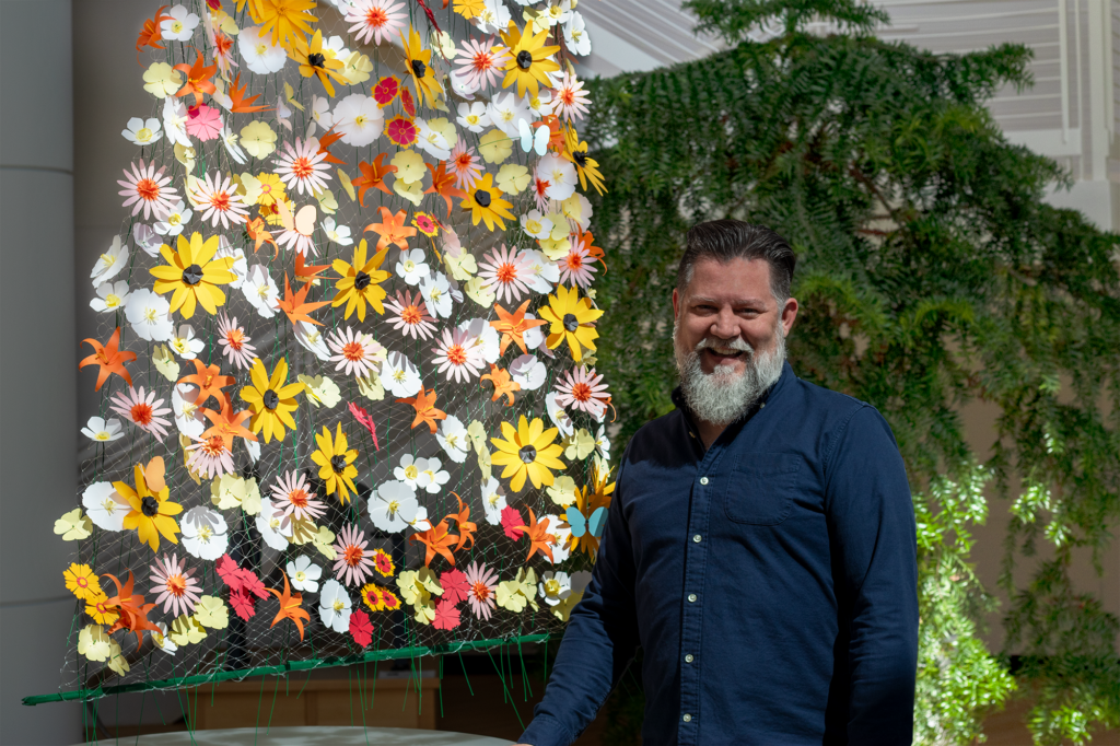 Michael Trutna, Talent Plus First Impressions Lead, stands next to his creation, FlowerFall