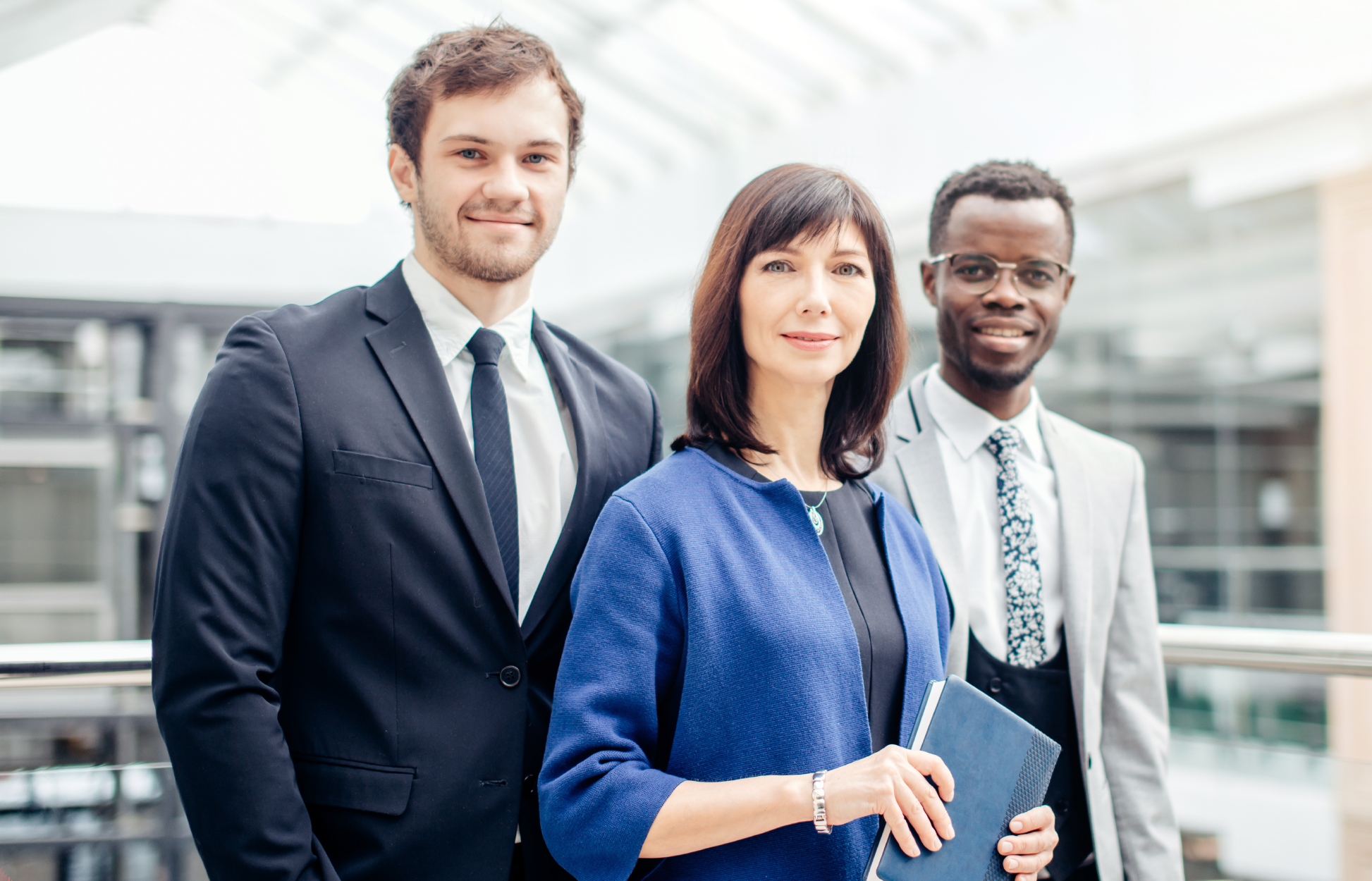 Group of three diverse employees at work.