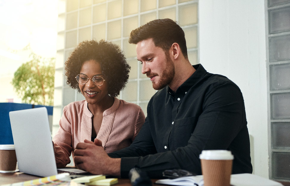 Two employees looking at ATS Software.